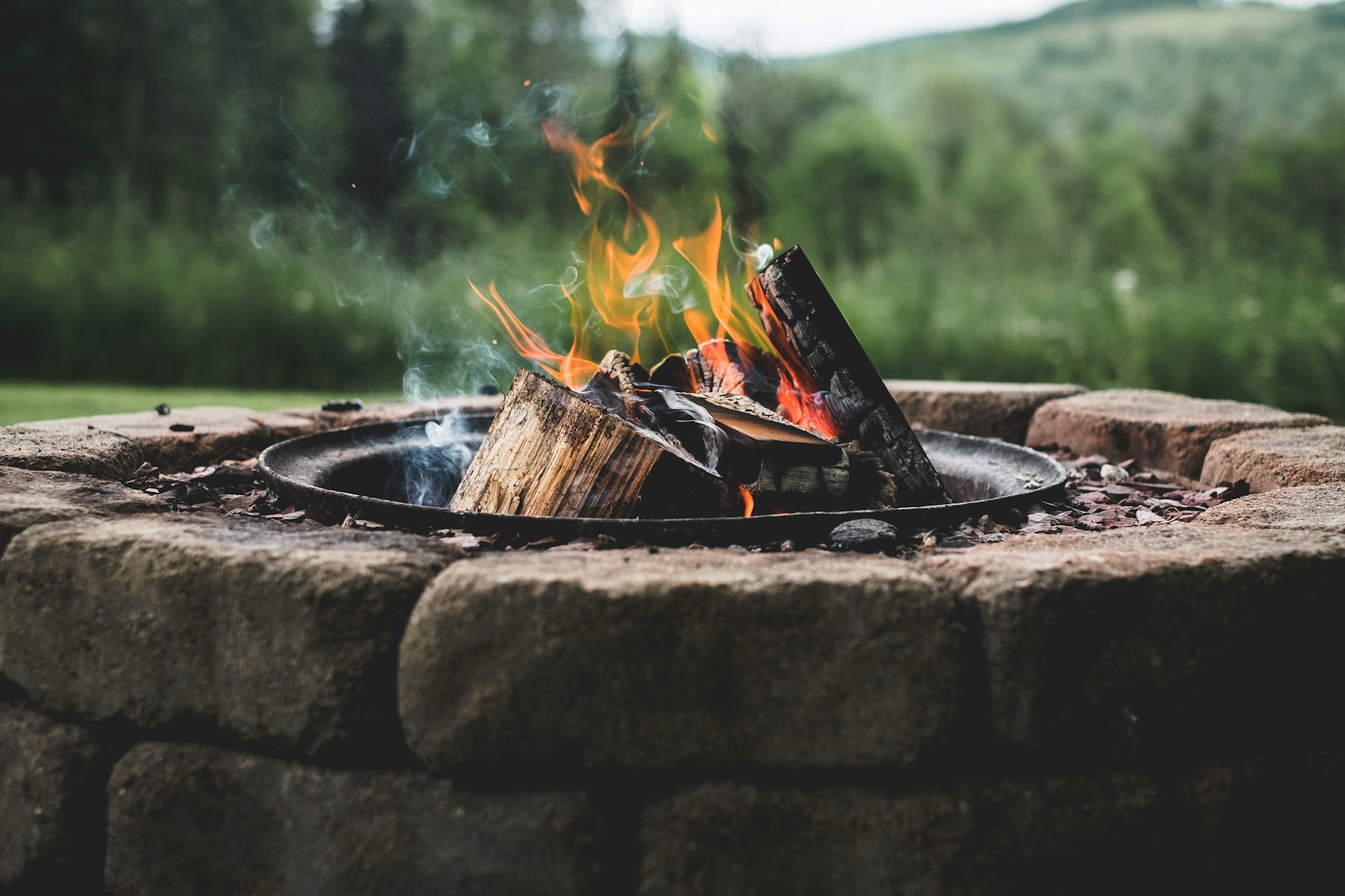 Fire pit overlooking woods and mountains in vermont