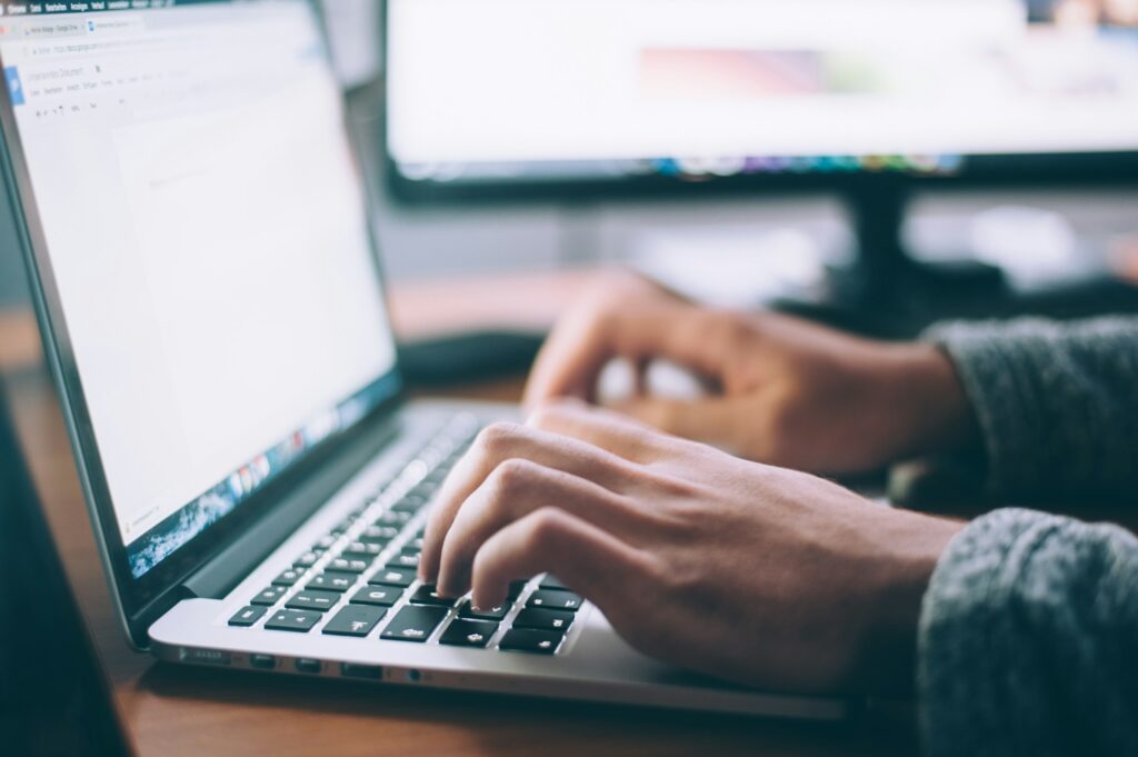 Person typing on business laptop