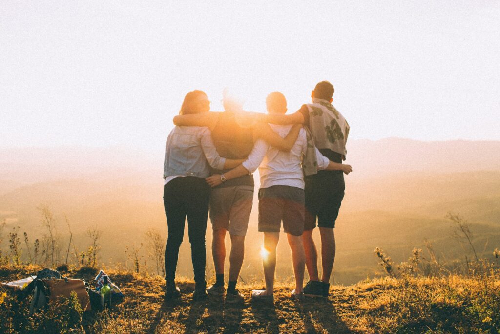 Group of people supporting each other at a summit
